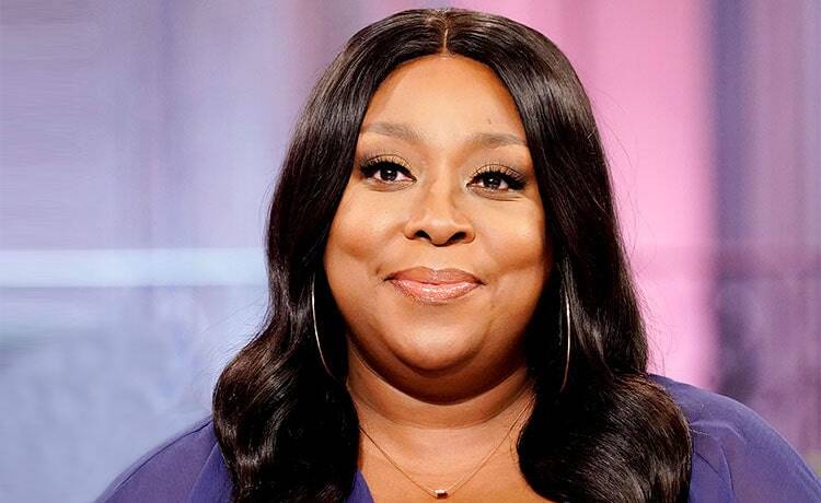 Loni Love, doing stand-up comedy.